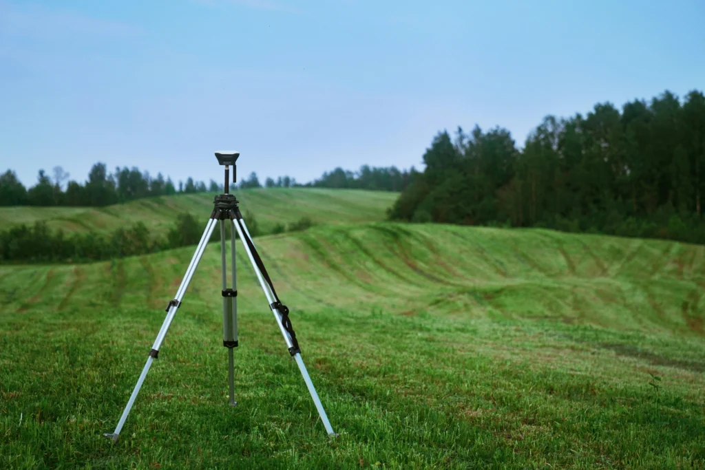 Plot area survey using surveying equipment for land measurement